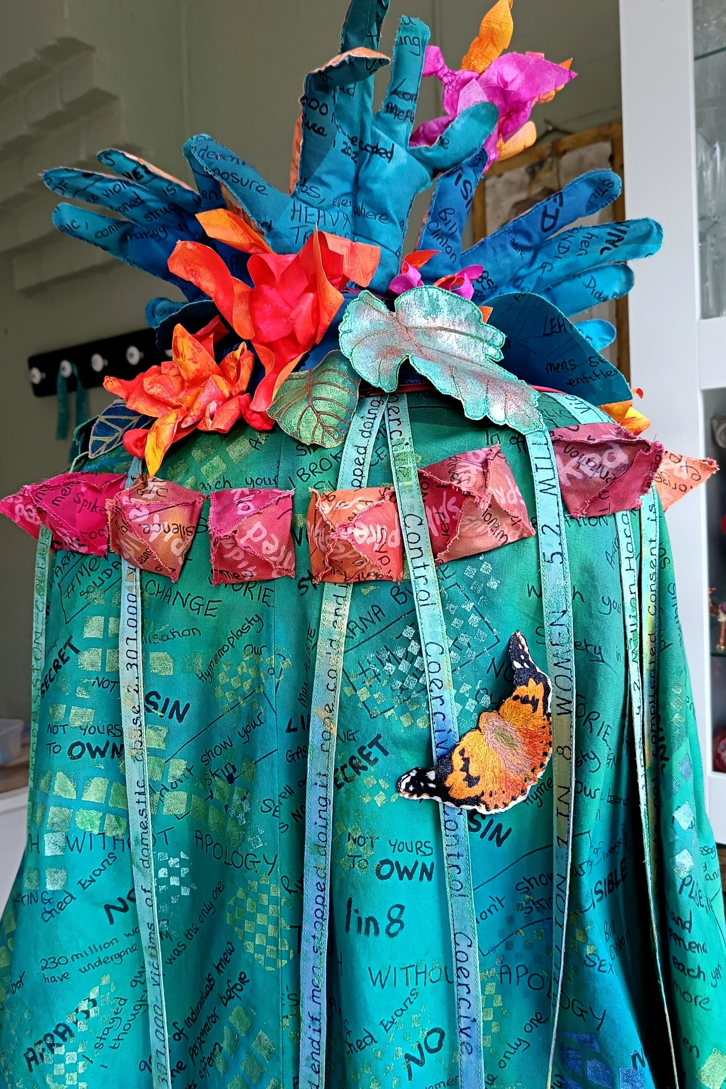 A look at the back of the Hobbled coat complete with Painted Lady butterfly, ribbons leaves and flowers.
