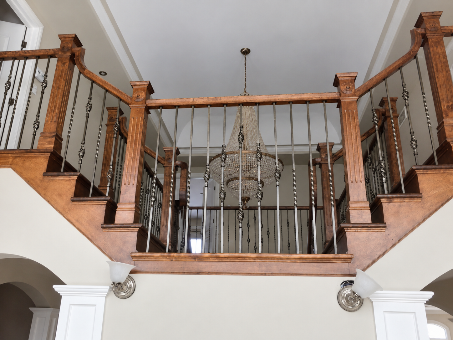 Bois-Franc two-storey stairwell with painted ceiling and chandelier