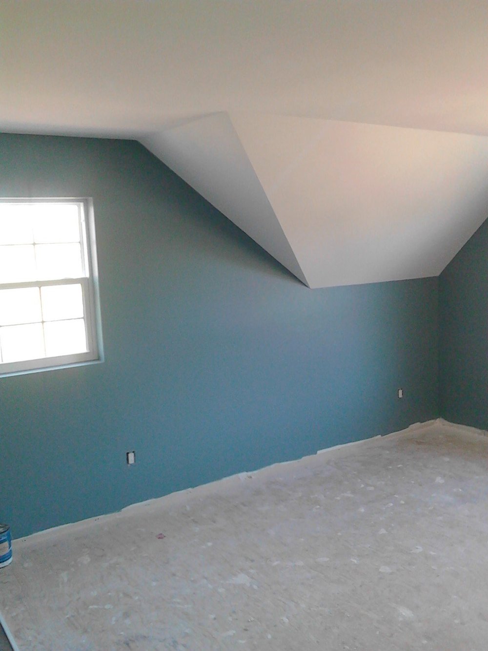 Blue room with an angled white ceiling