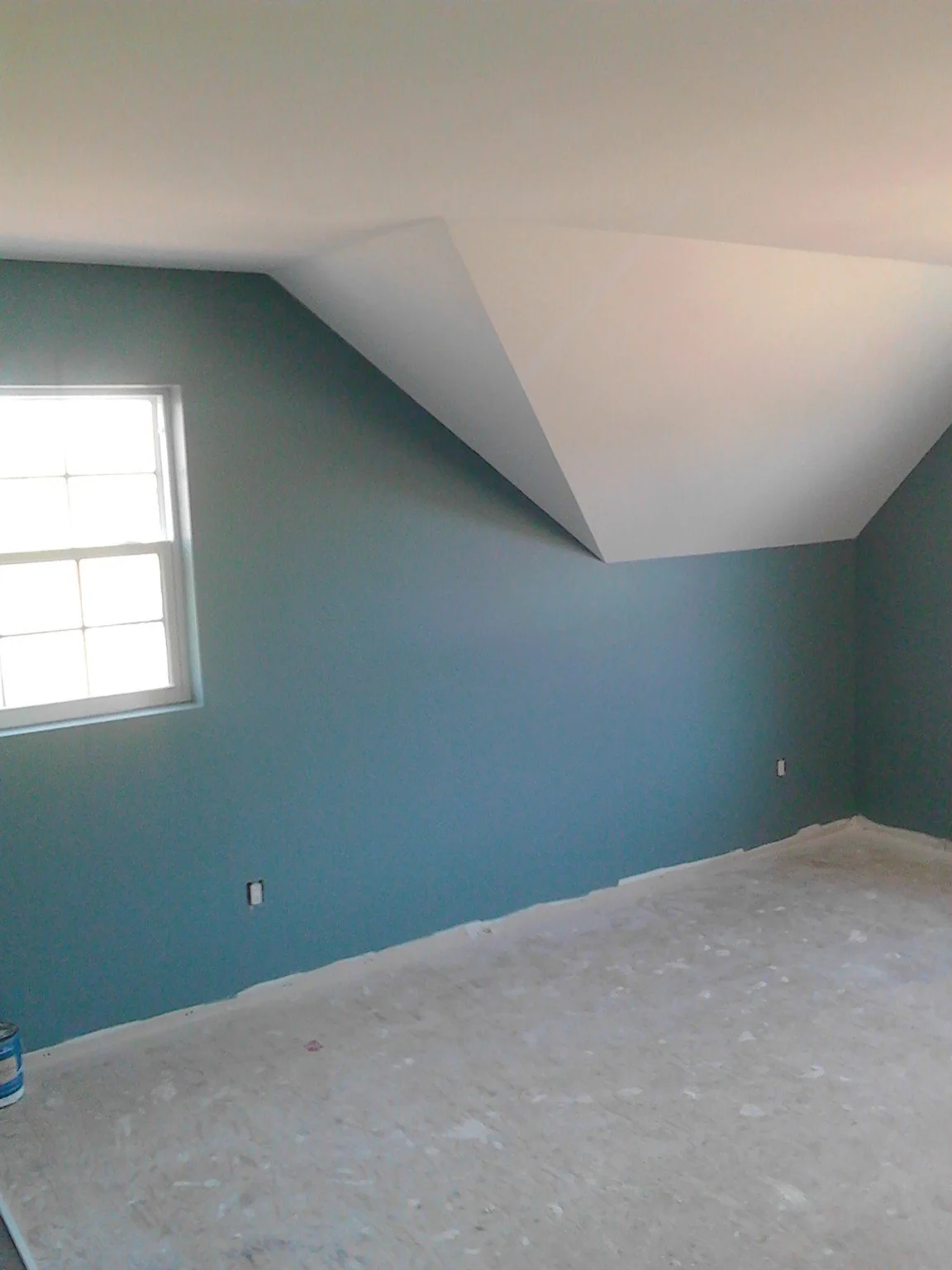 Blue painted room with a sloped ceiling in a Beaconsfield home