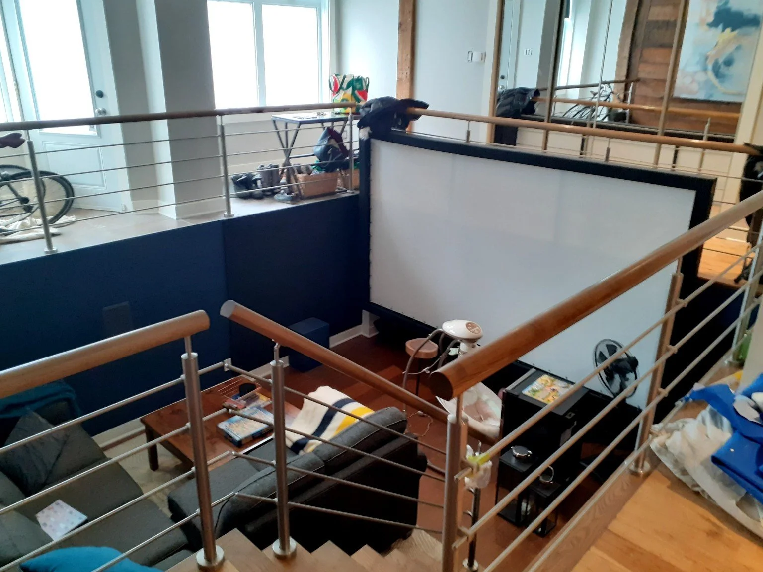 Painted Plateau condo interior with a railing overlooking a sunken TV den