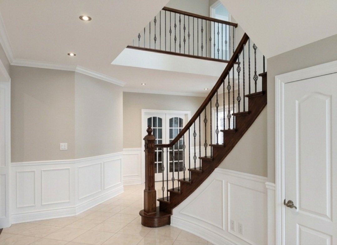 Detailed skilled painting of decorative trim, french doors and entry hallway in Bois Franc. in