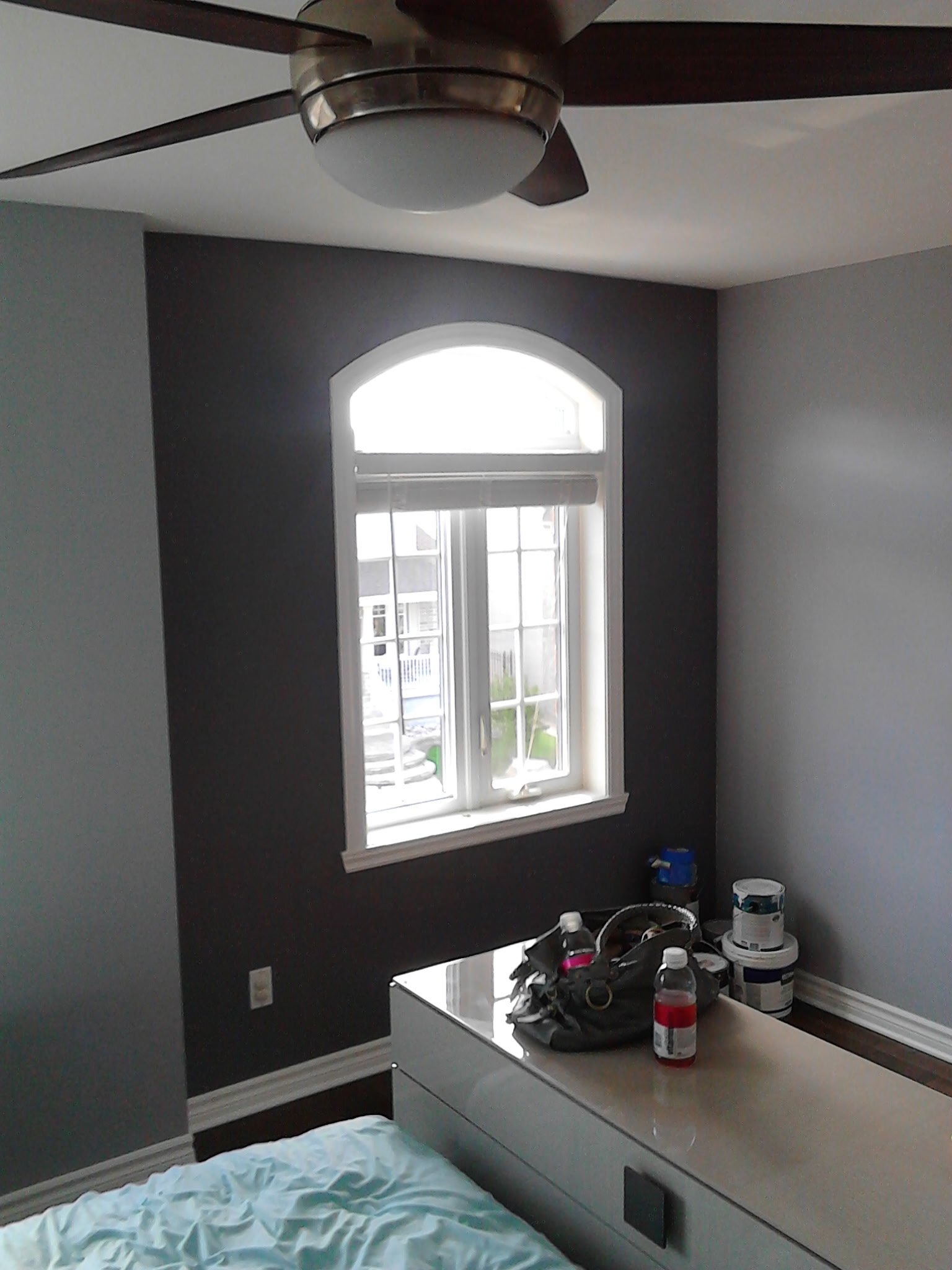 Modern interior residential painting featuring a dark navy accent wall in Pincourt.