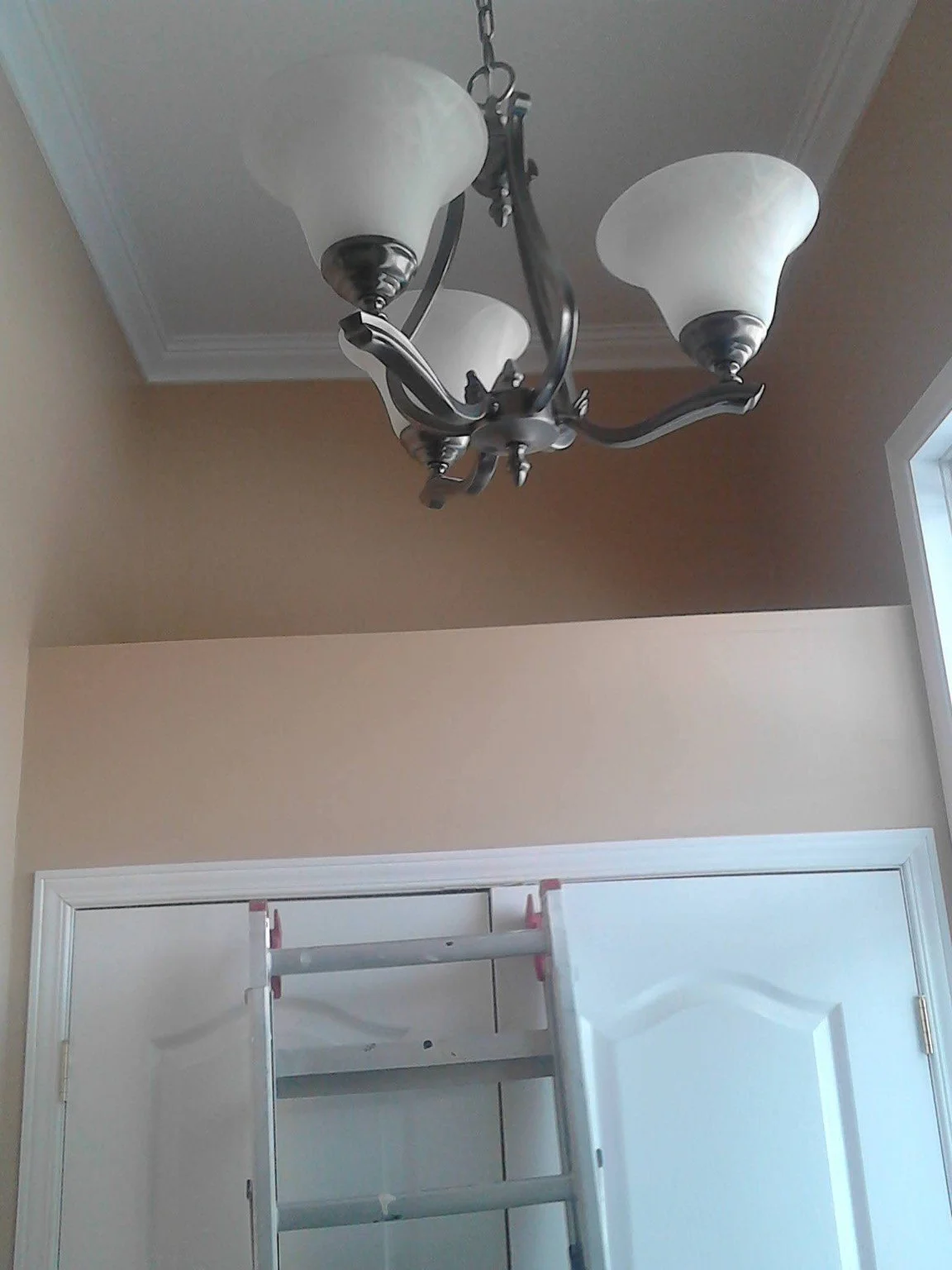 Painted entryway ceiling above double doors and hanging light fixture