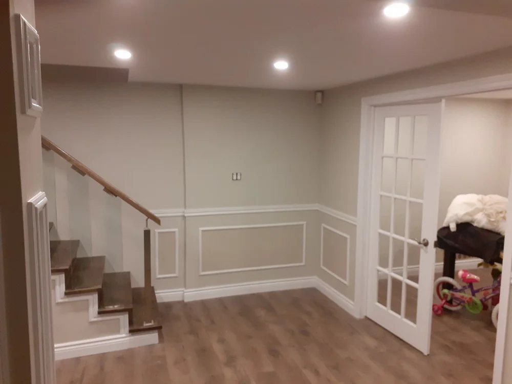Basement with freshly painted wainscoting and trim