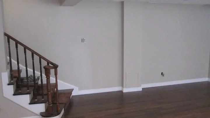 Côte-Saint-Luc basement interior with pale painted walls and wood flooring