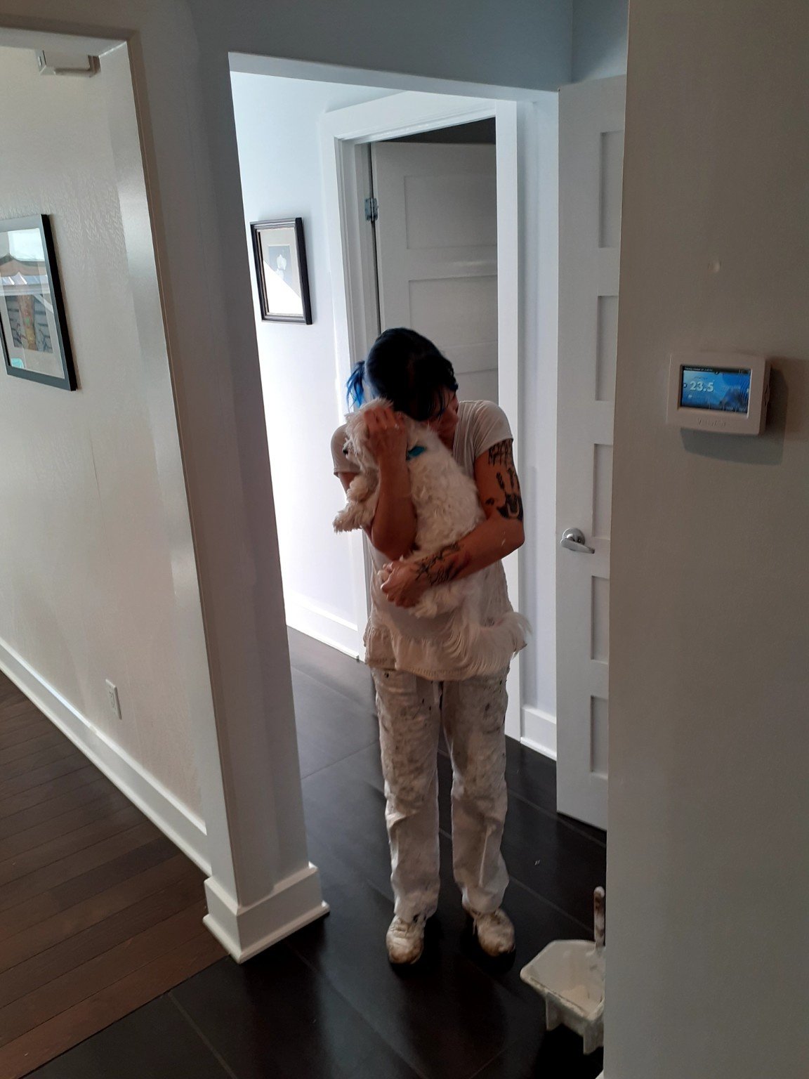 Amanda hugging a client’s dog at a work site