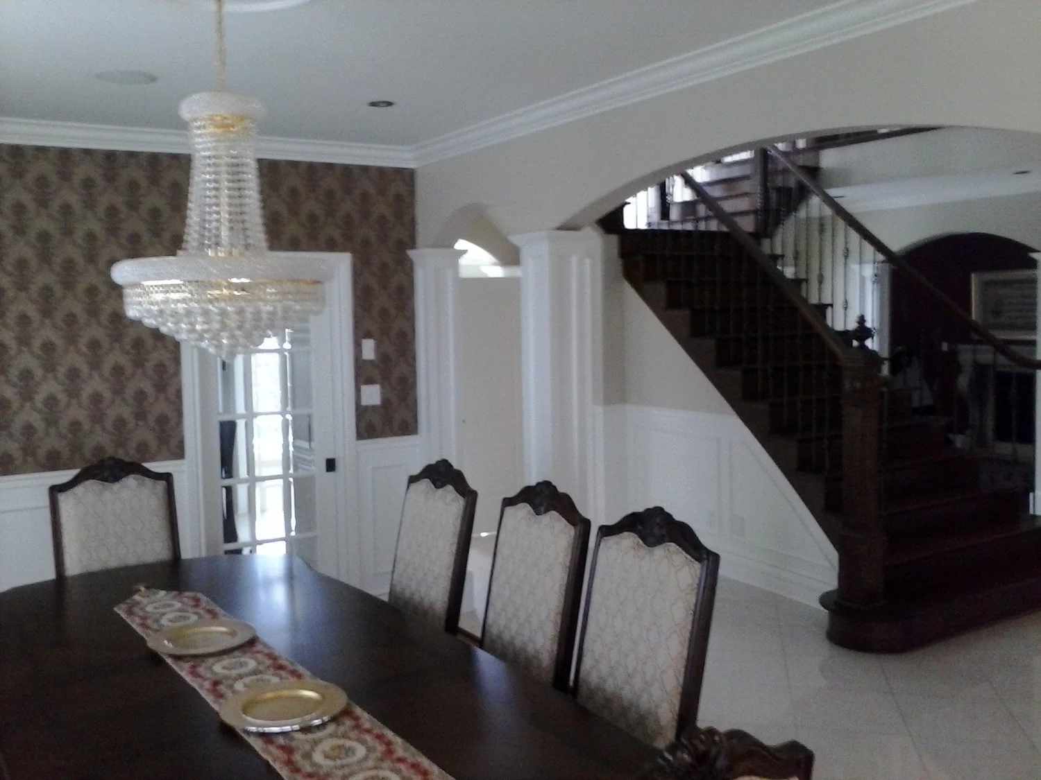Finished dining and living areas with a view toward the staircase
