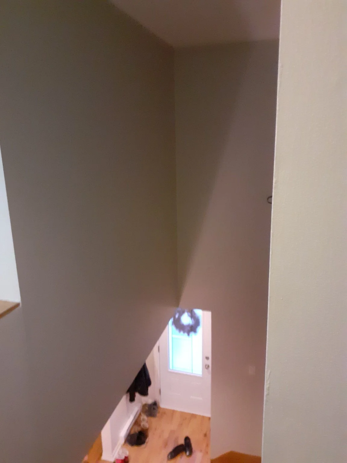 Interior stairwell and painted walls viewed downward from the landing