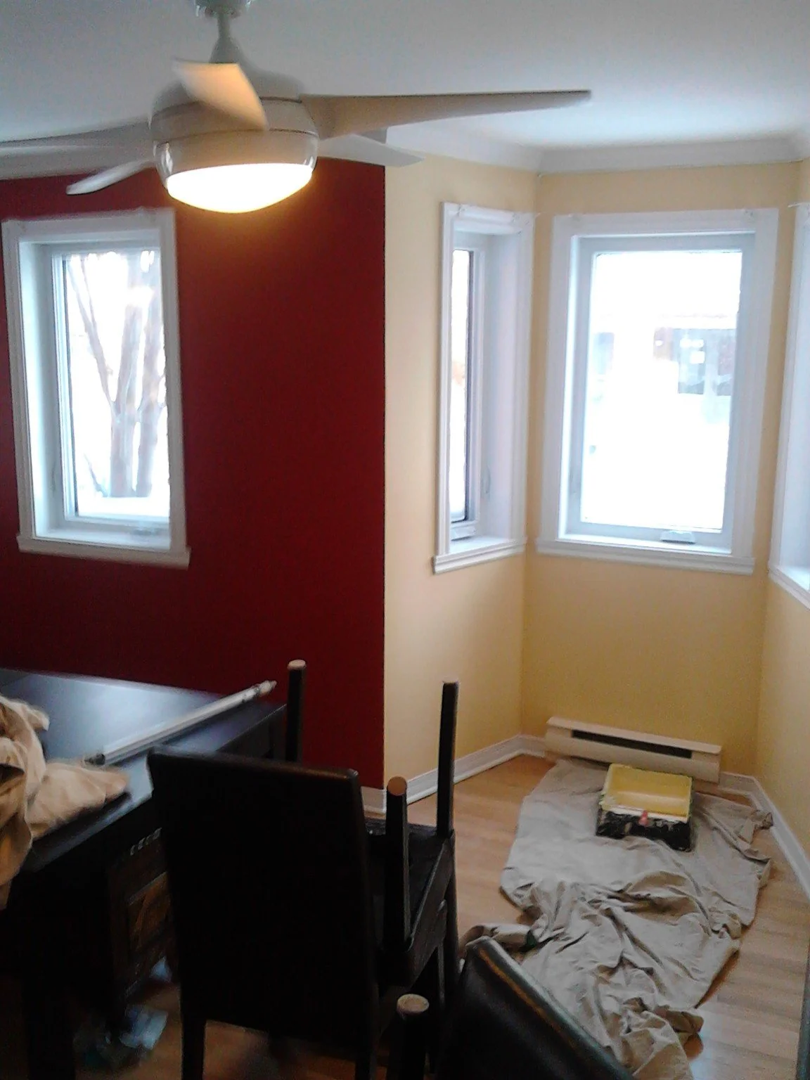 Burgundy accent wall beside windows in a residential room
