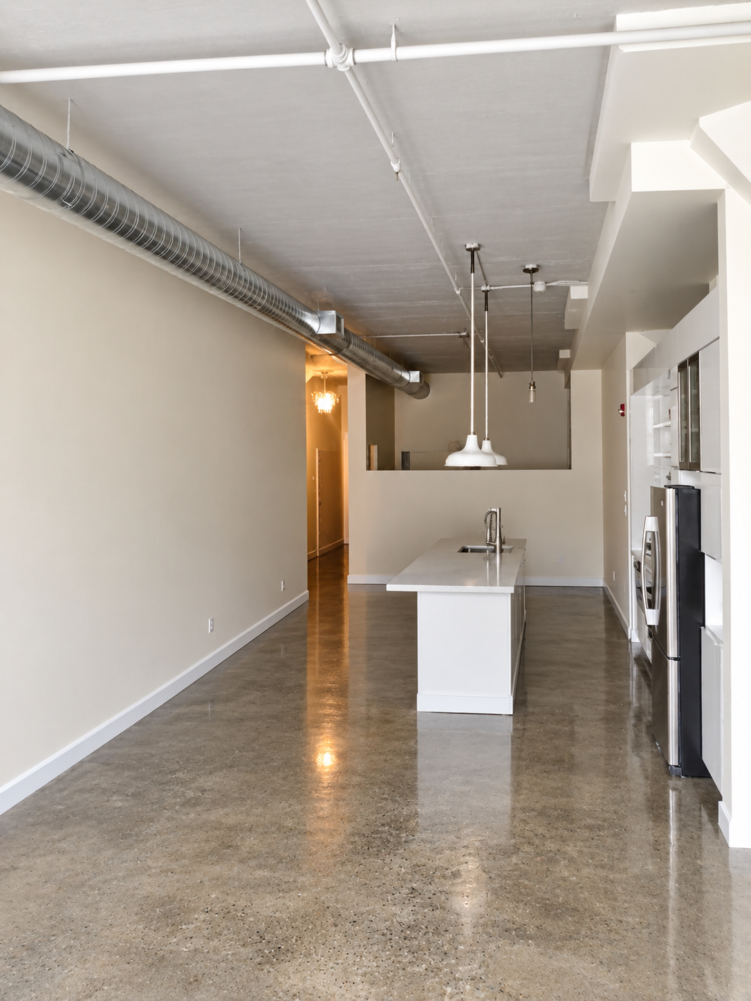 Griffintown condo with an open living and kitchen area, painted walls and large windows