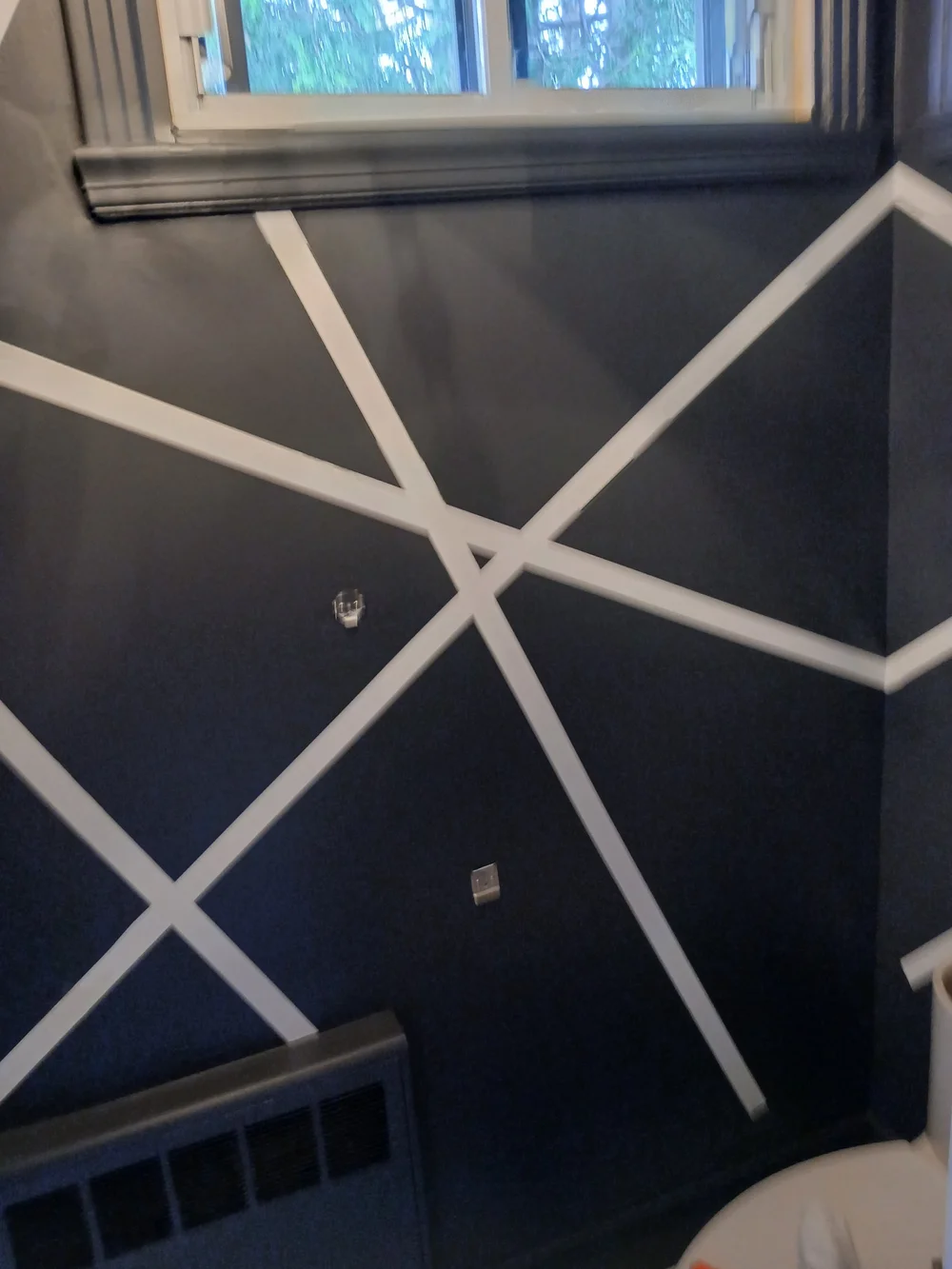 Dark bathroom wall with white geometric line design