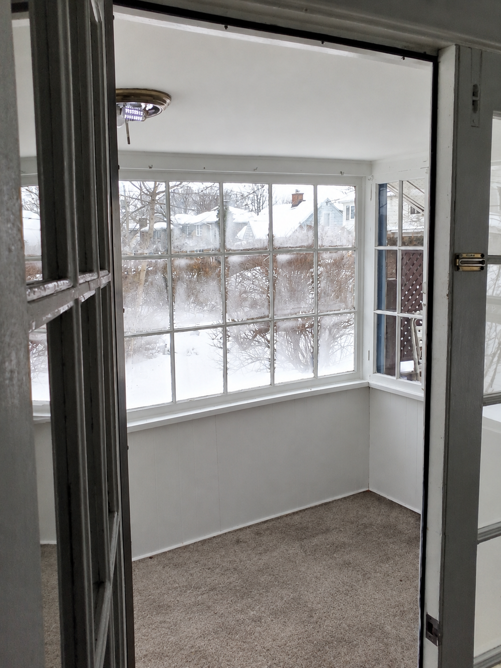 Bright sunroom overlooking a snowy yard