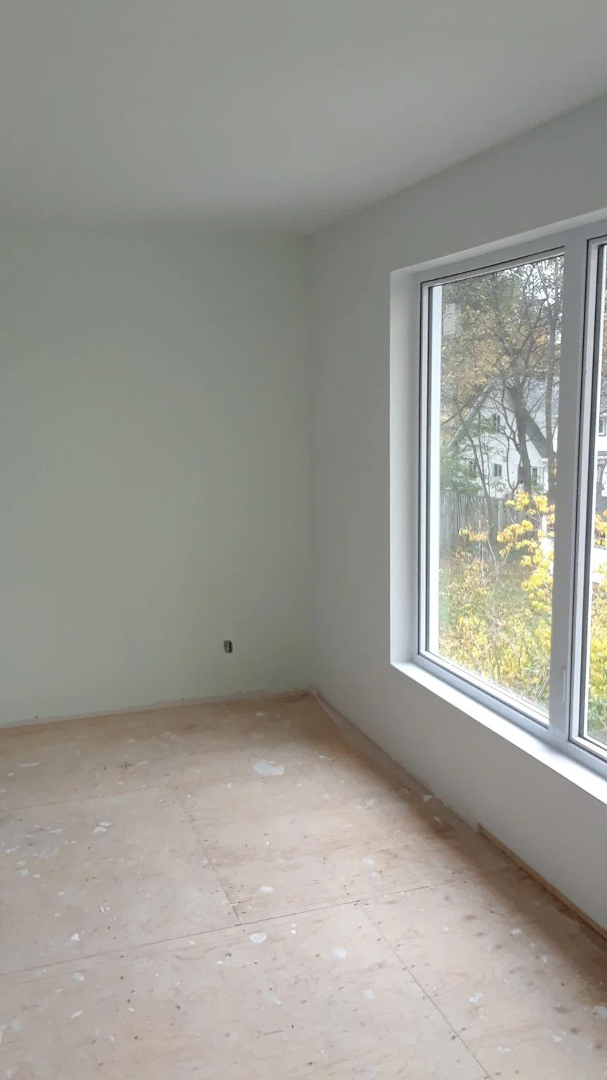Côte-Saint-Luc living room with pale painted walls and a large window