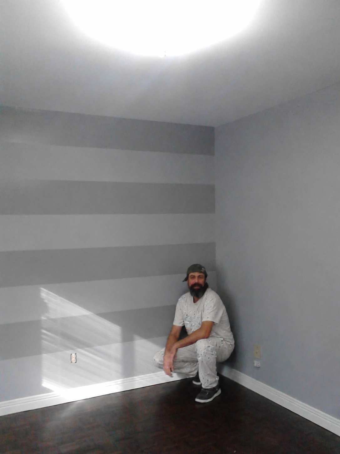 Joel with a grey striped feature wall