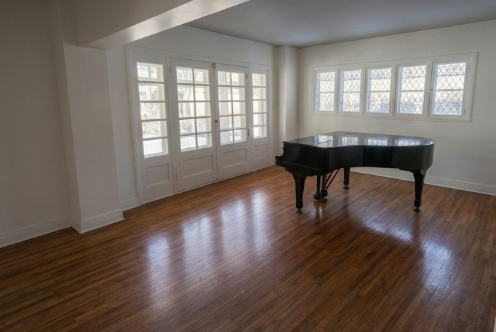 Town of Mount Royal living room with painted walls, white French doors, wood floors and a piano