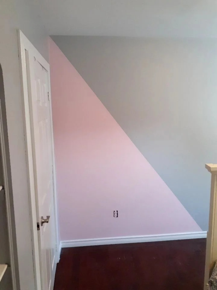 Pink diagonal design painted beside an interior doorway