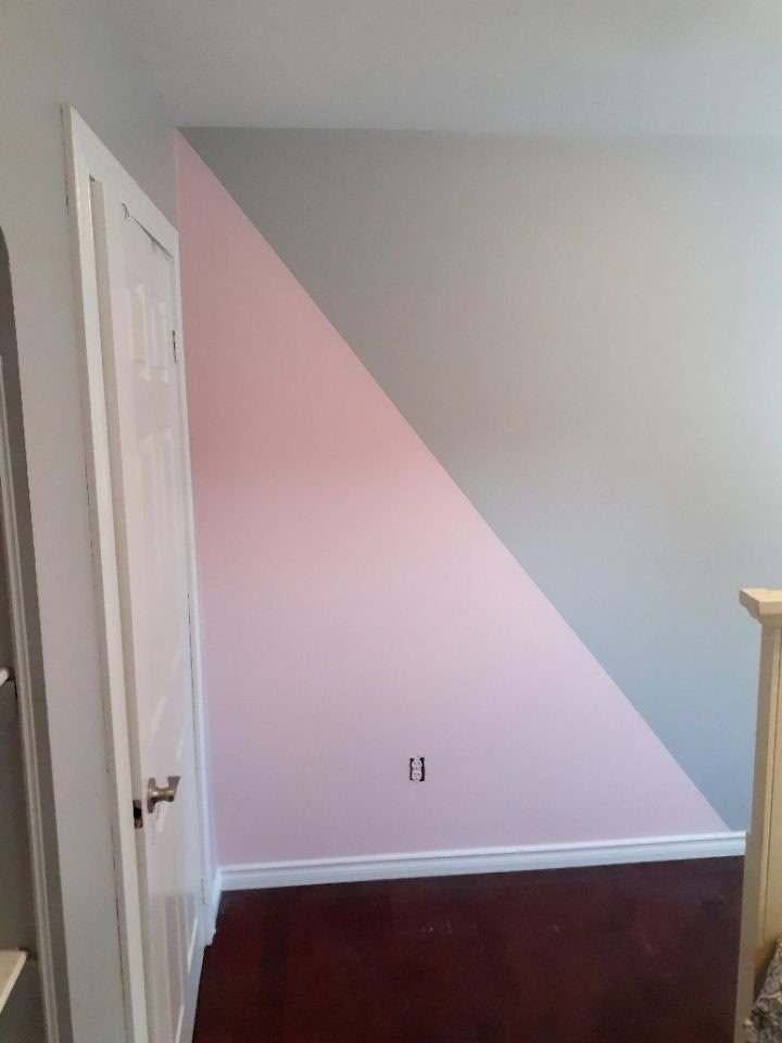 Pink diagonal accent design painted beside an interior doorway