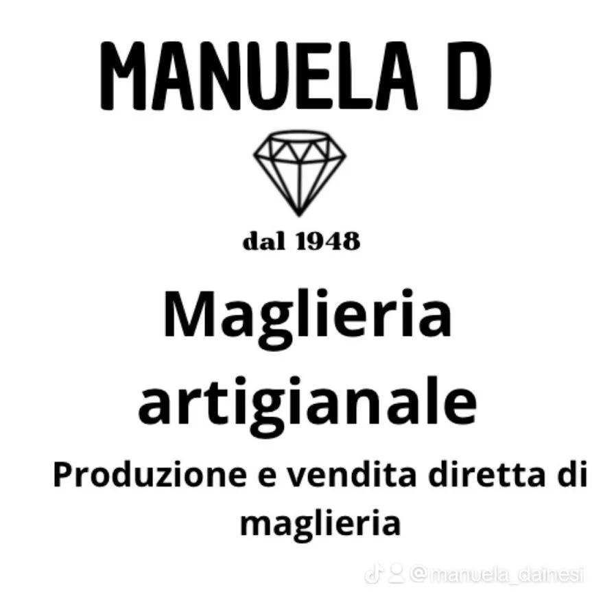 Sign for Manuela D, a handmade jewelry shop established in 1948, featuring a diamond icon and text in Italian about direct production and sale of jewelry.