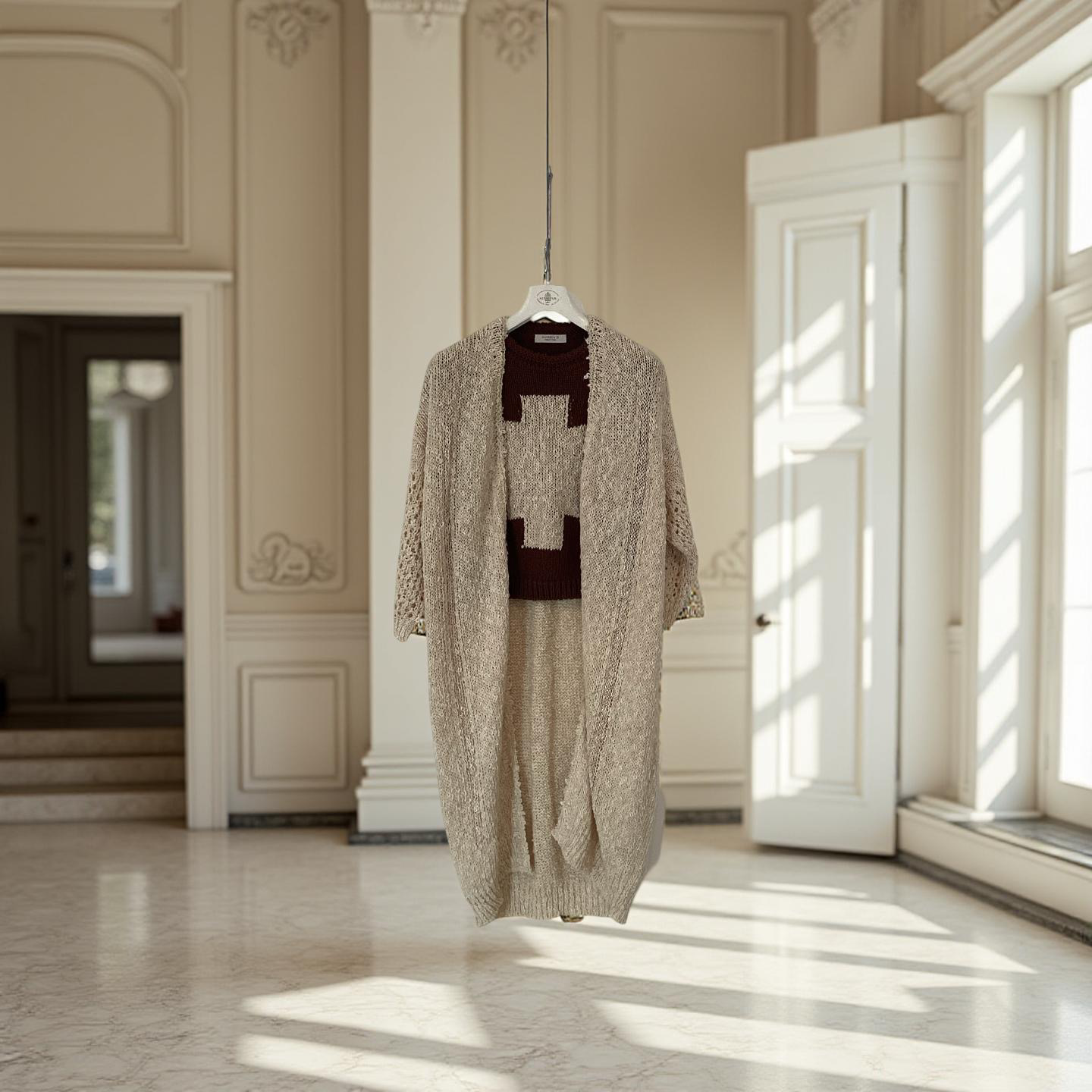 A beige textured coat with a matching knit outfit hanging on a clothes hanger, suspended in a bright room with sunlight streaming through large white paneled windows.