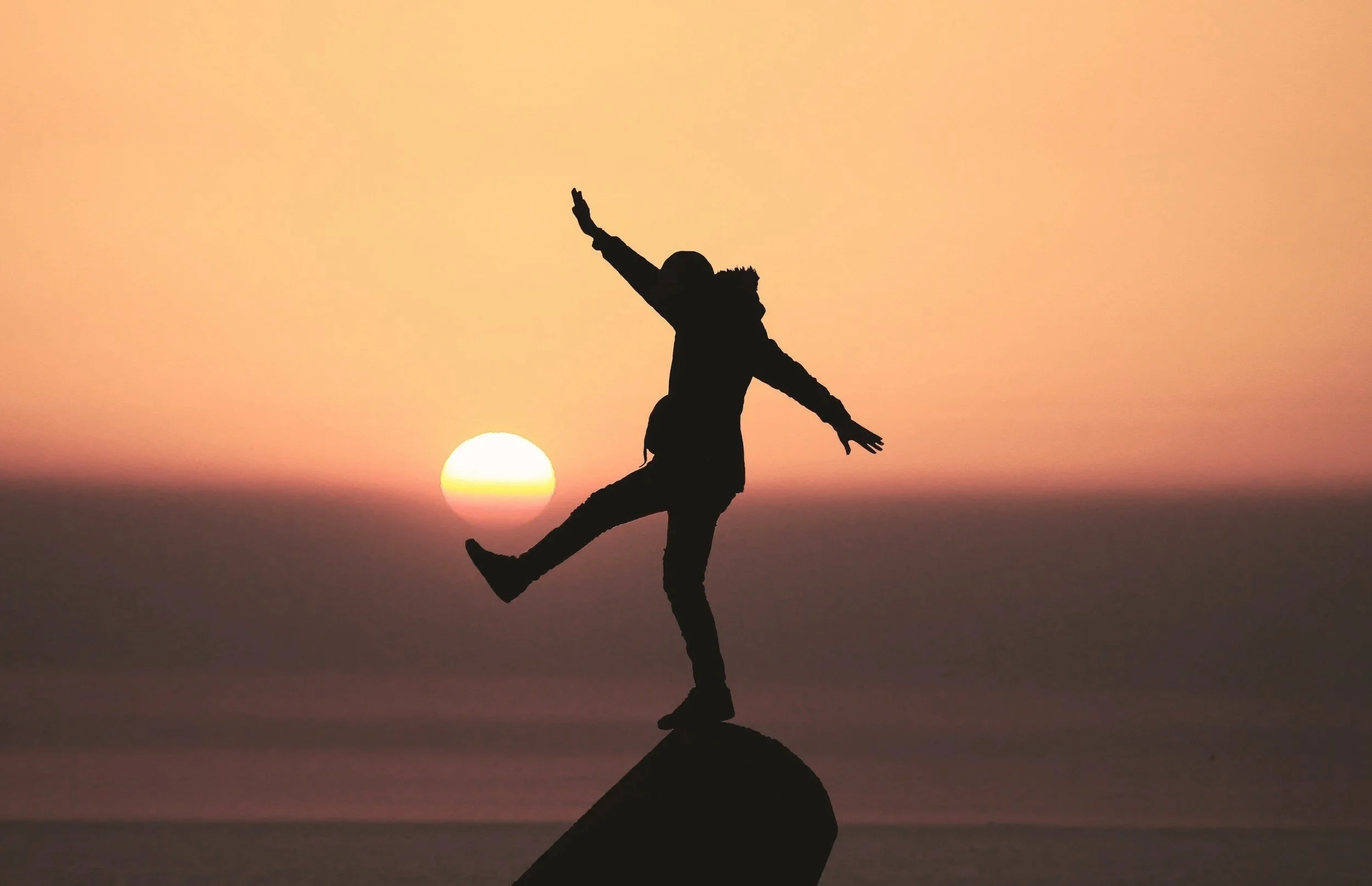 person hiking at sunset
