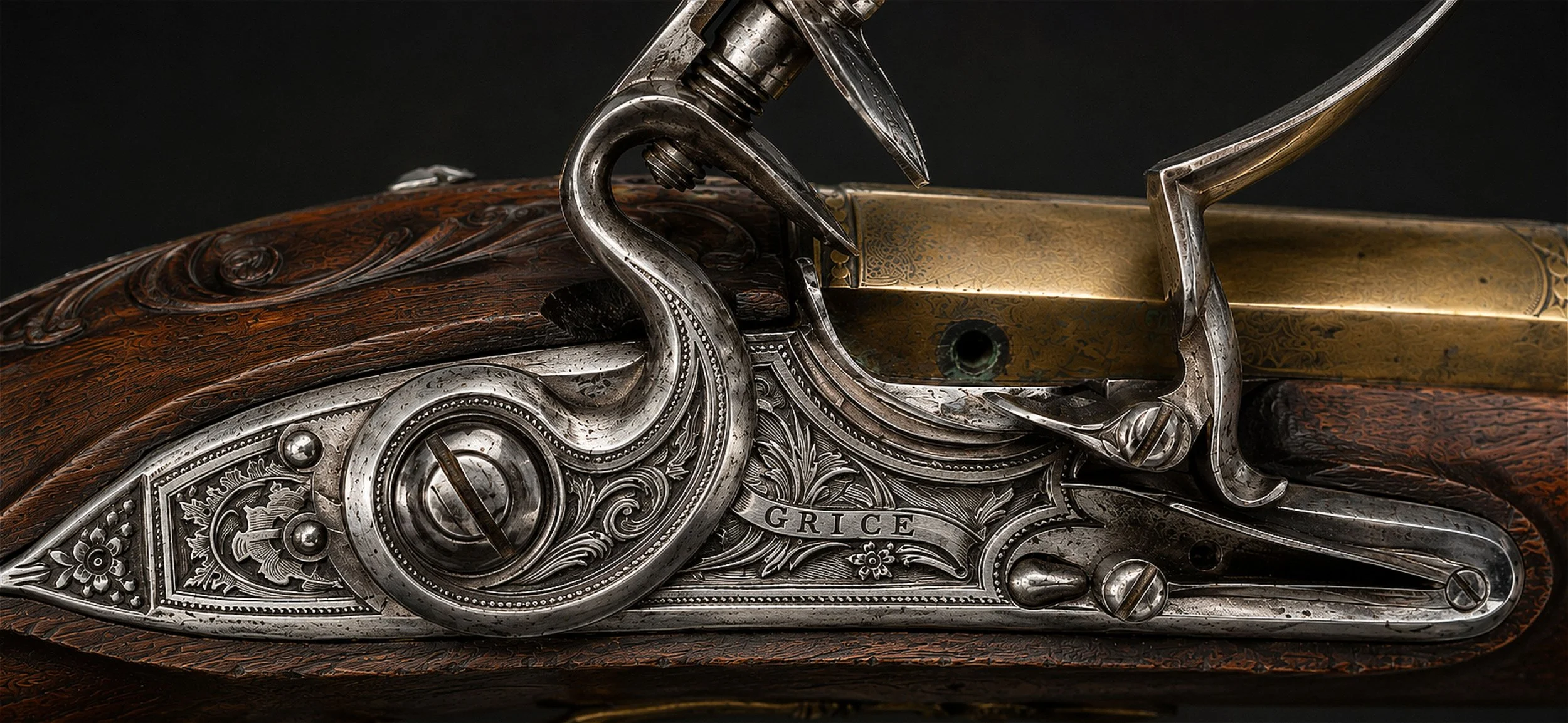 Close-up of a vintage engraved rifle with a carved wooden stock and metal details, including the name 'Grice' engraved on the side.