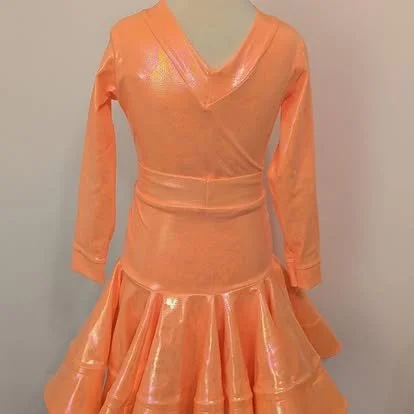 Peach-colored dress with long sleeves and a layered, ruffled skirt.
