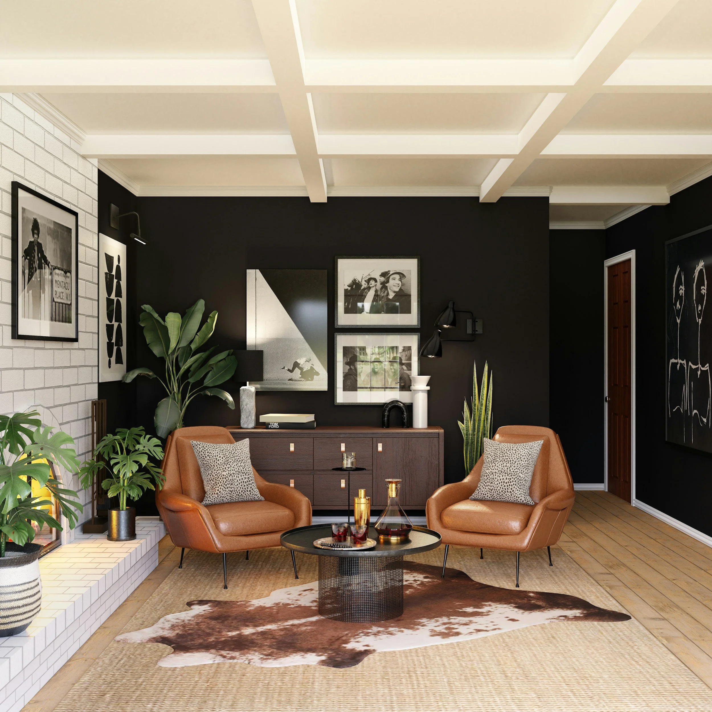 Living room with black and white framed photos on the wall, brown leather chairs with patterned pillows, a small black round coffee table with gold accents, and large green plants, with a cowhide area rug and wood flooring.
