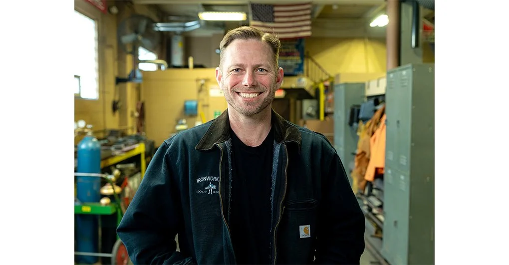Headshot of Brian Poindexter standing in a workshop