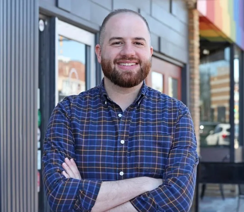 Headshot of Jeremy Moss standing in front of a store front
