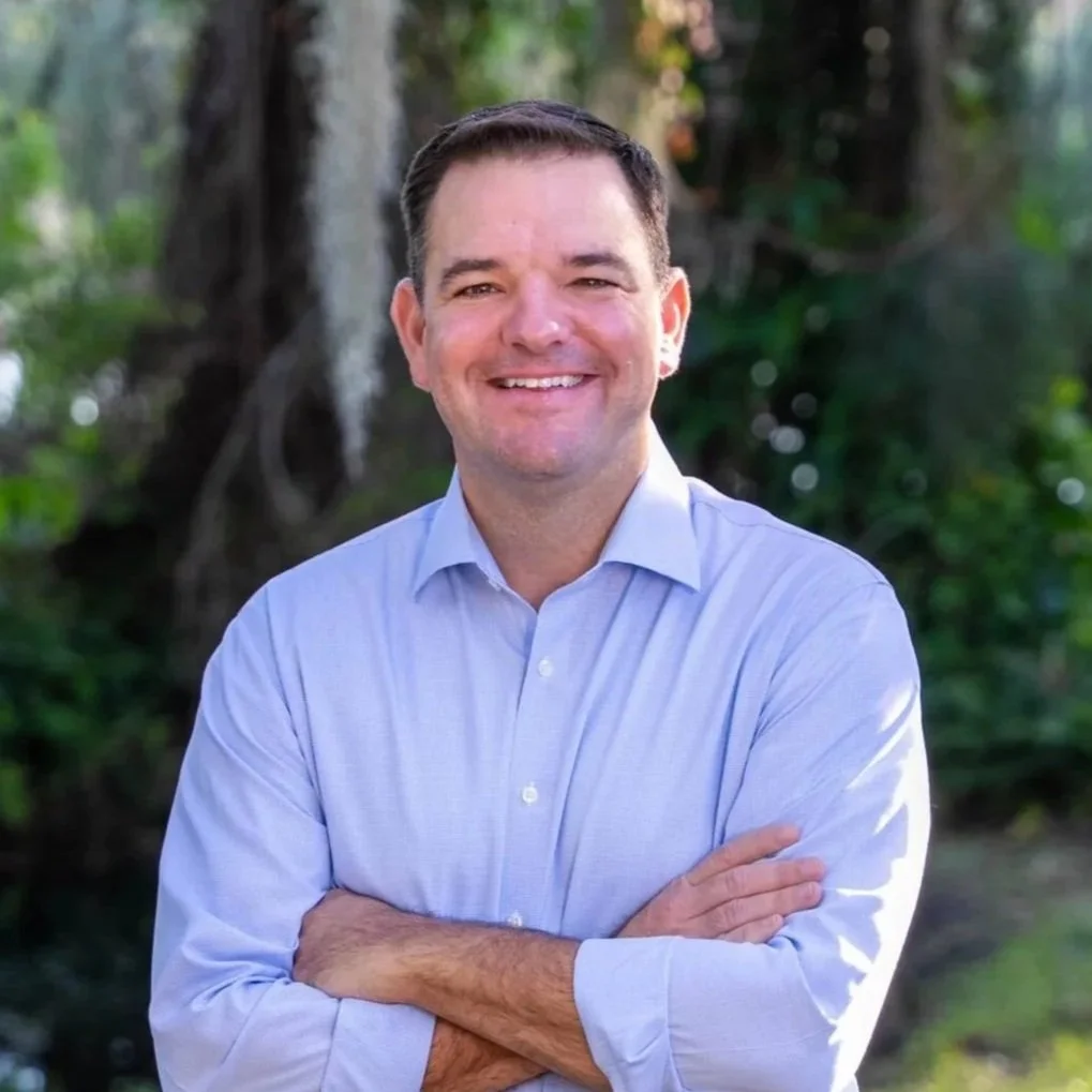 Headshot of Bale Dalton standing outside smiling at the camera with his arms crossed