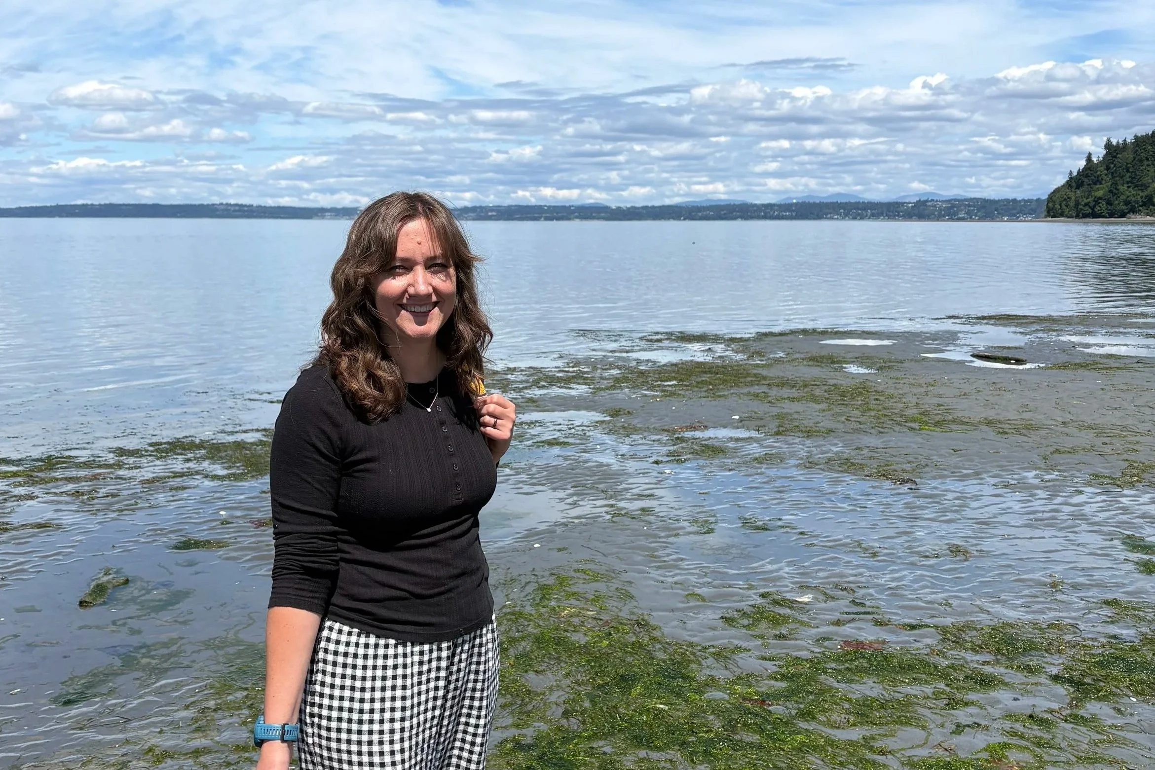 Stephanie on vacation in front of a lake.