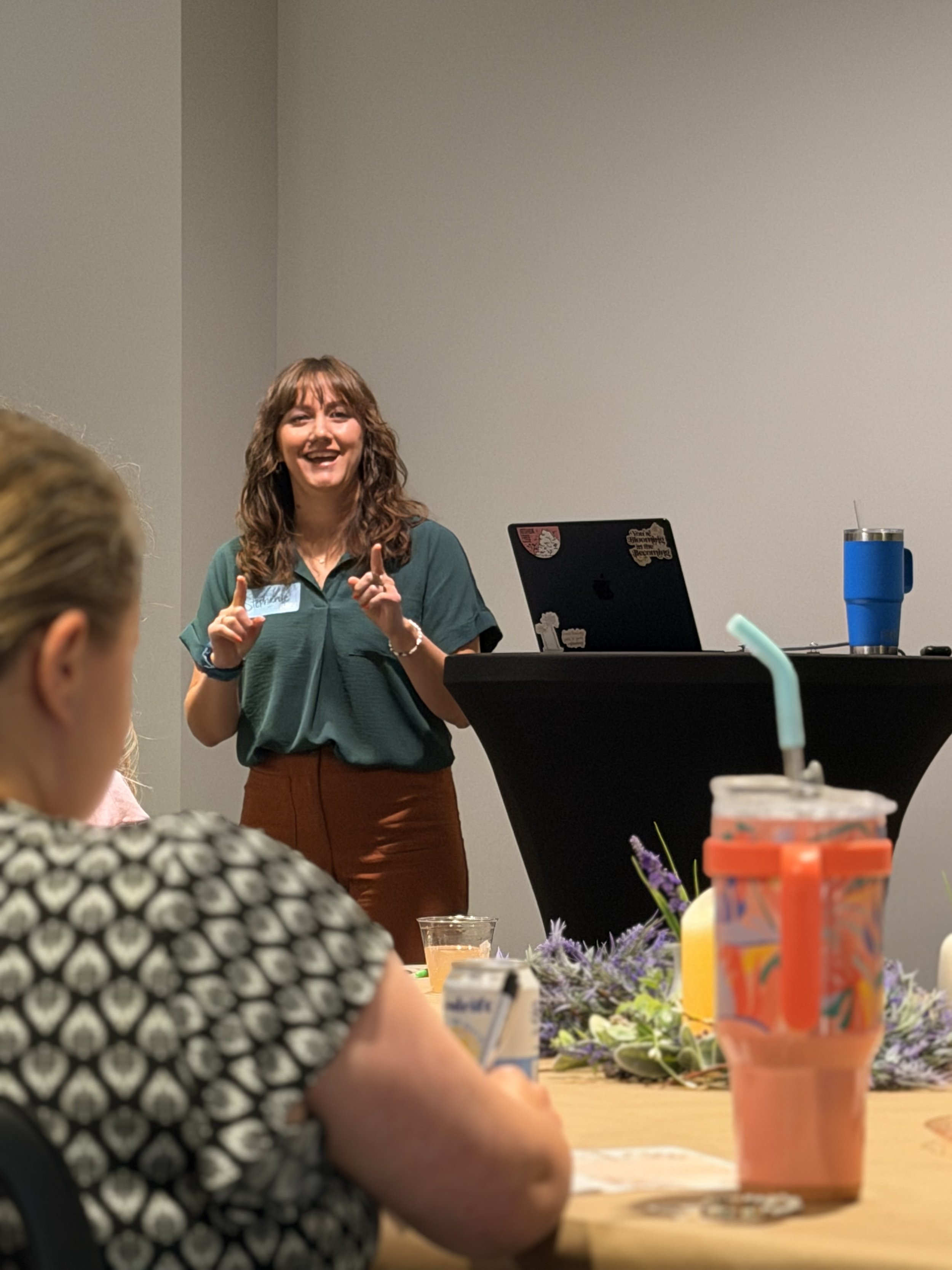 Stephanie at a podium speaking to CE students.