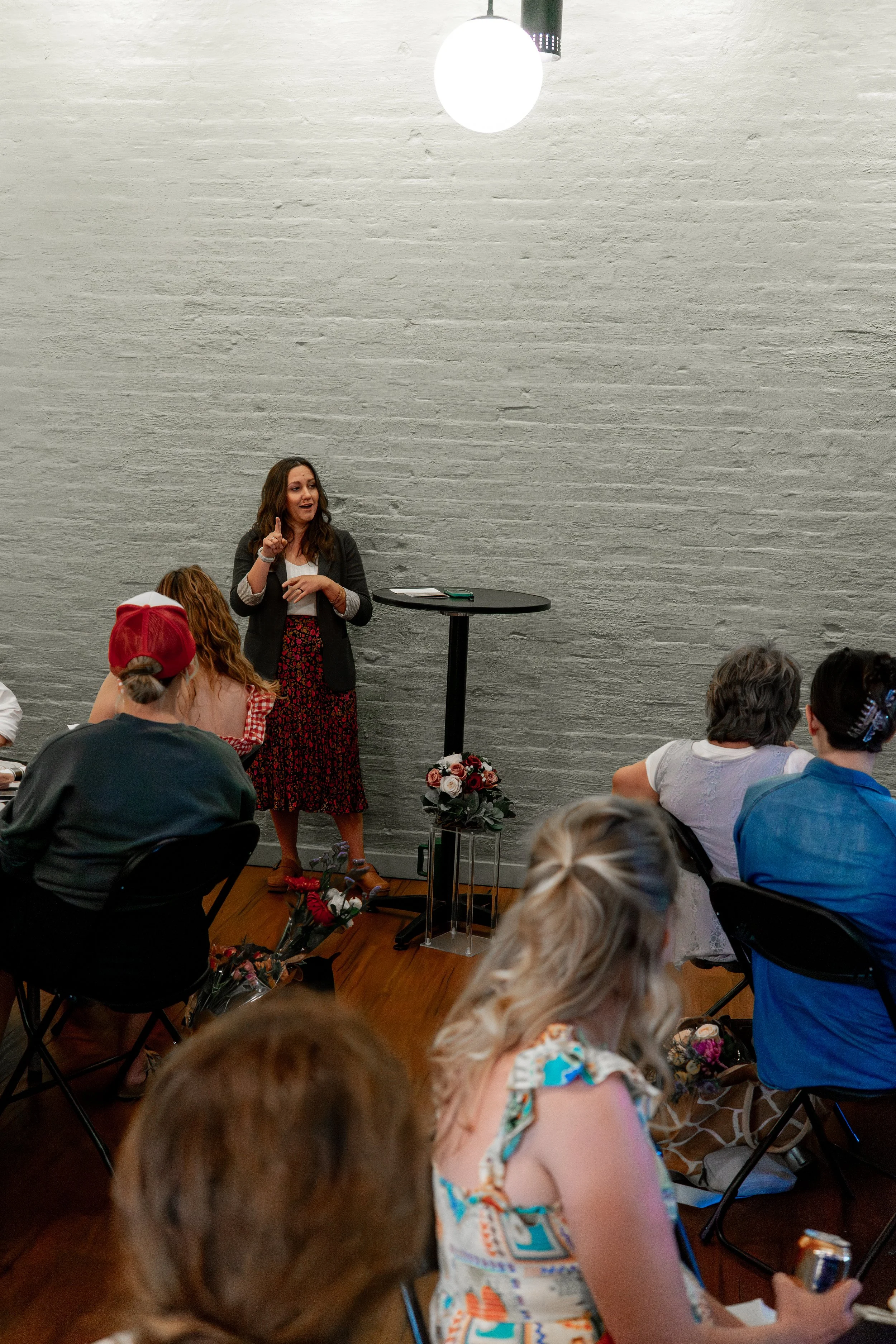 Stephanie speaking in front of a group of people