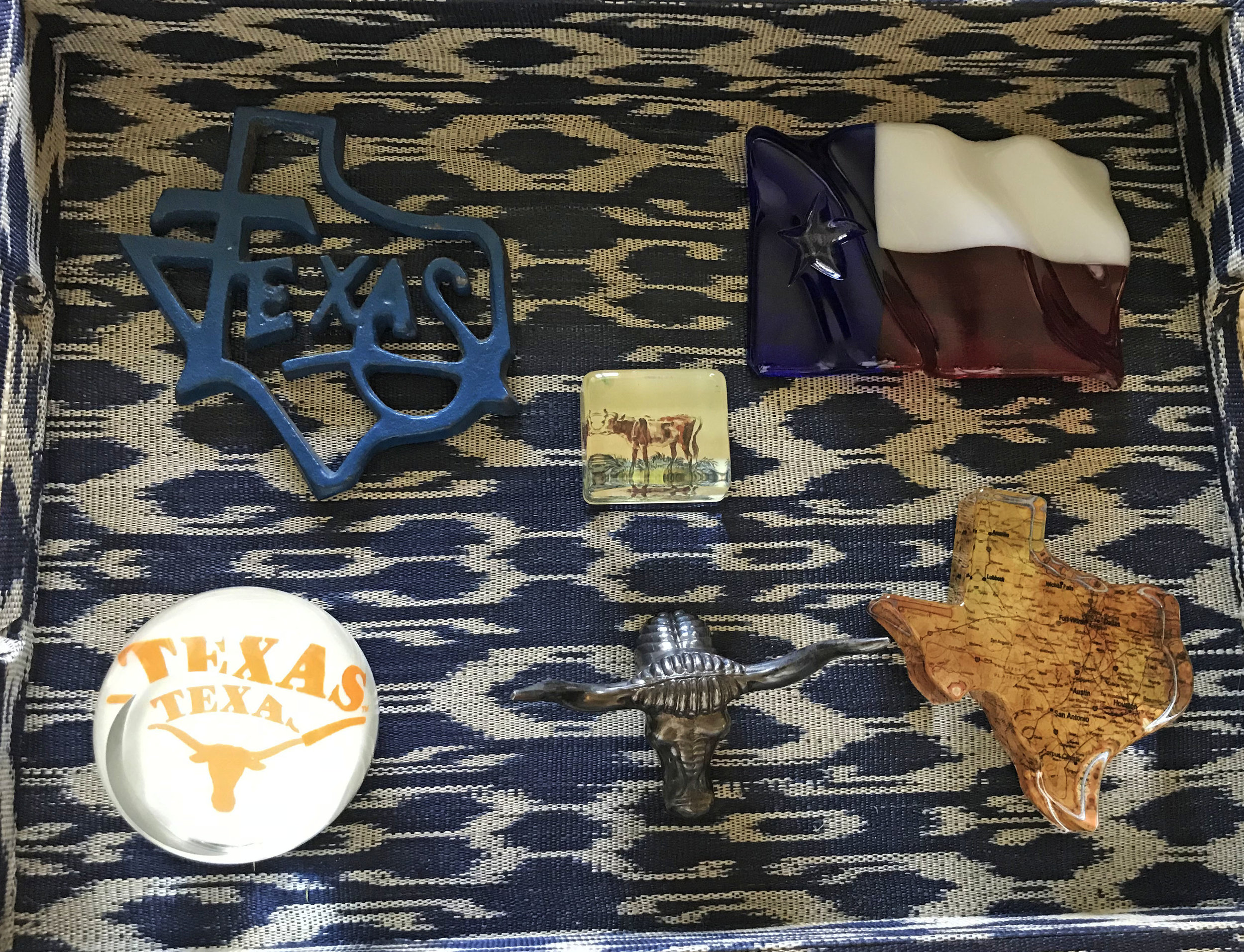 In another tray my client displays Texas paperweights. Paperweights are one of my favorite things to collect because they are affordable and come in so many shapes and sizes. Collecting with a theme is so much fun and makes gift giving super easy.