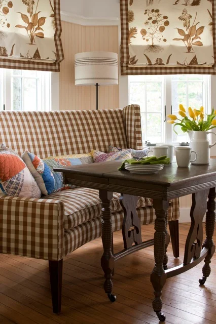 I matched the breakfast banquette fabric to that of the window treatments for a seamless feel throughout this kitchen nook.