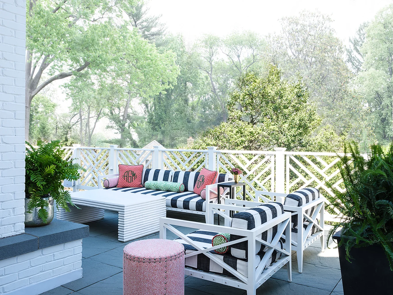 Here, the more muted tones allow the coral to really pop and make this terrace space inviting.