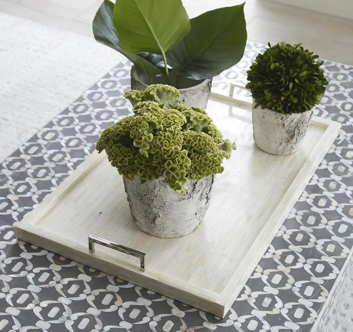 This neutral bone and nickel tray by Wisteria is classic and refined.