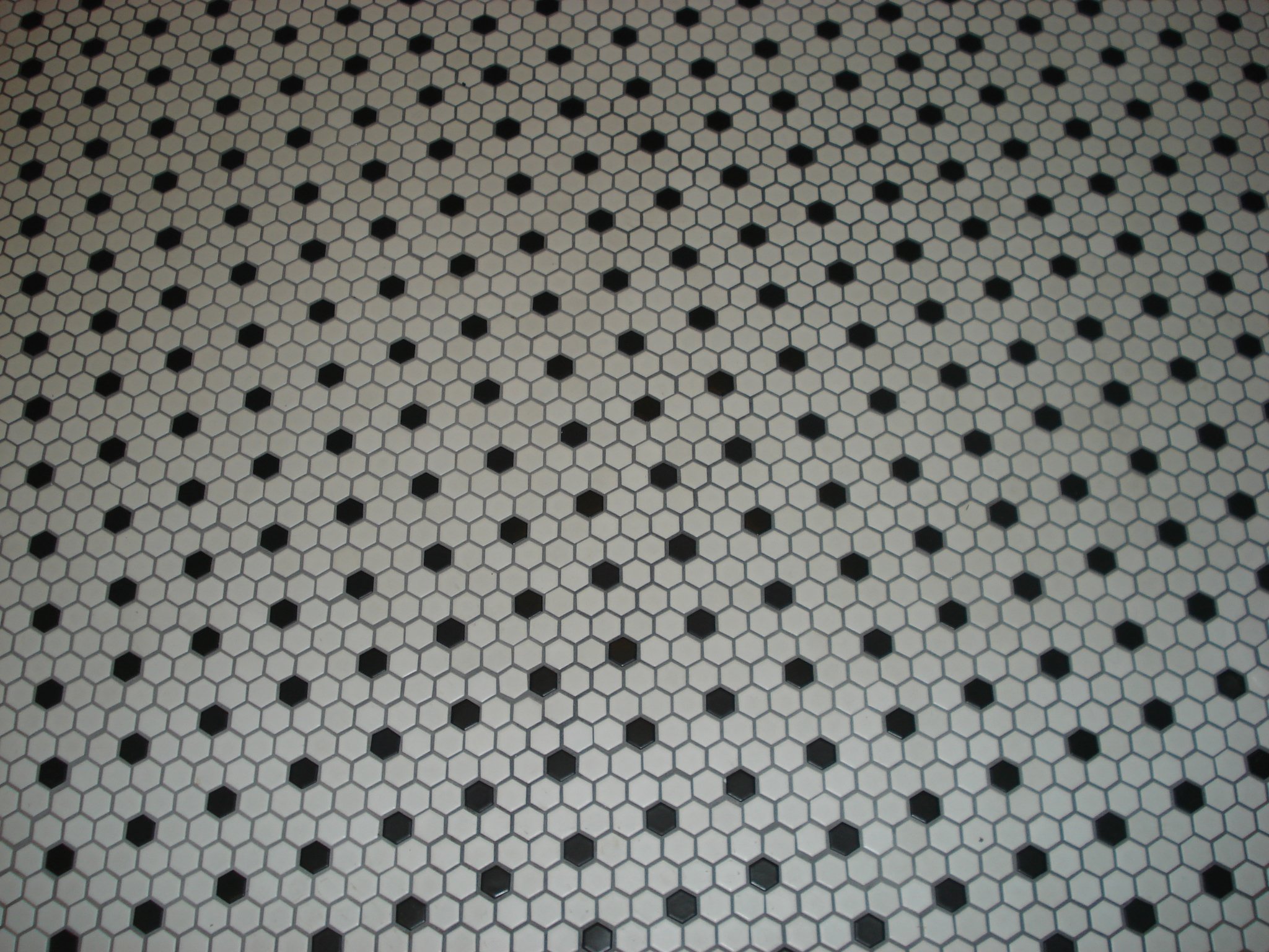 Close-up of a black and white hexagonal tile floor.