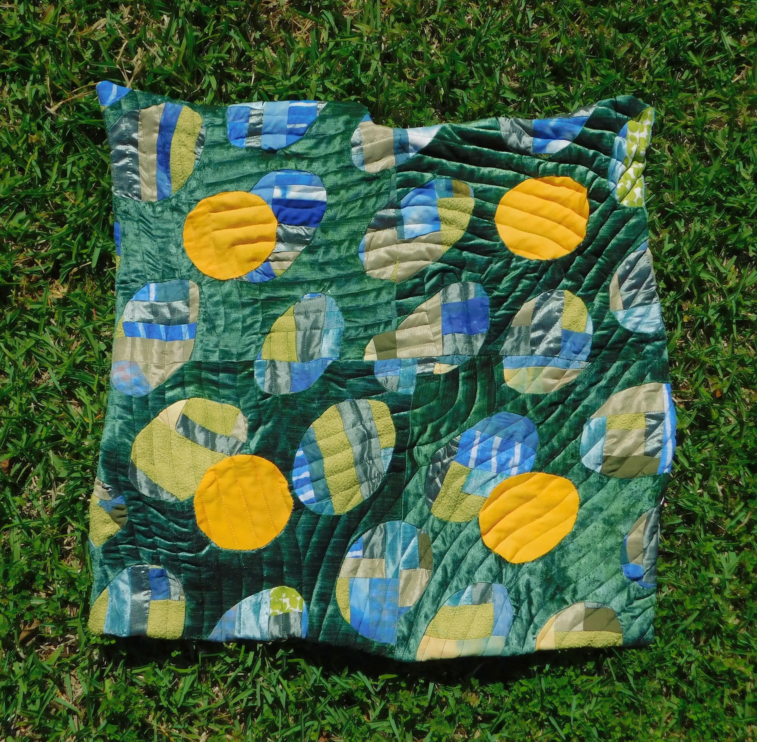 Finished quilt,
Hand dyed velvet, scraps from multiple past projects, dip tests, and the circles are hand dyed cotton sheets, I was inspired by the top of rippling water. I often picture a landscape below the surface but this time I observed from abo