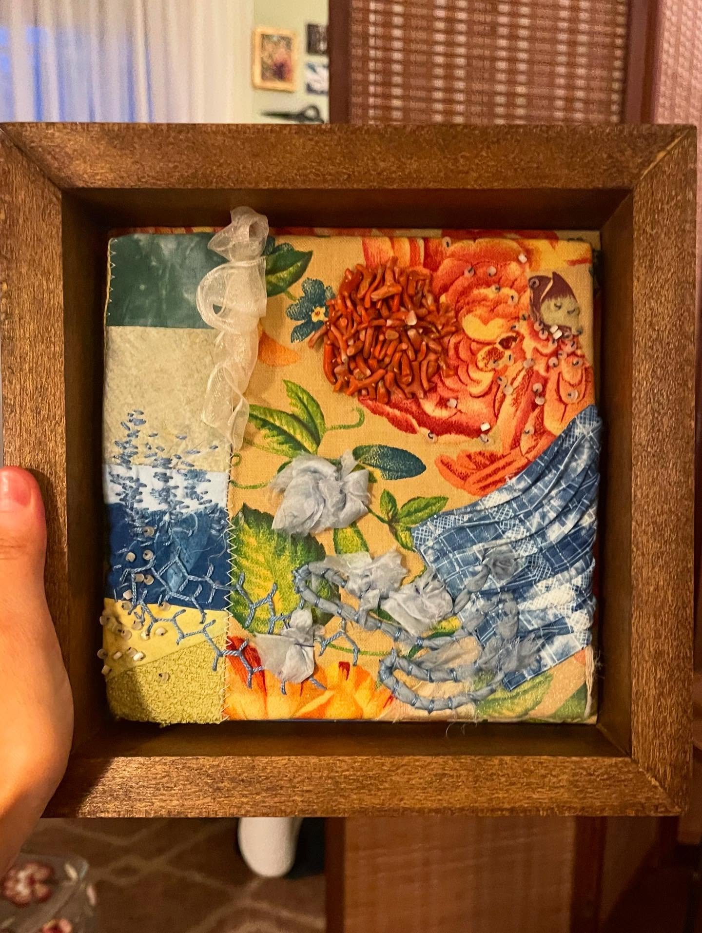 Fiber work made with fabric, coral beads, thread, silk, sashiko thread, and indigo scraps. A study of material and color