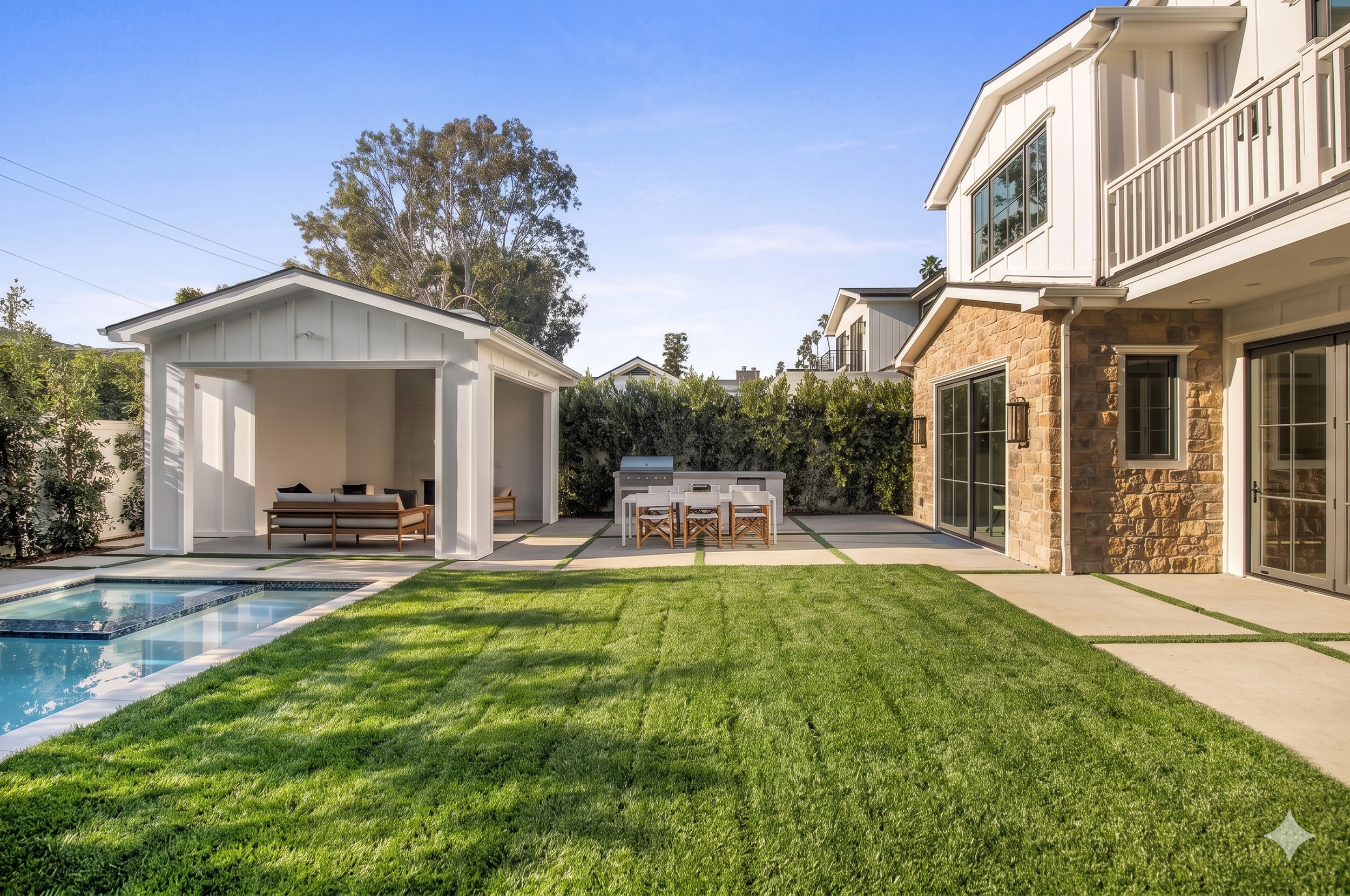 Modern farmhouse with pool and spa glowing at twilight under a pink sky, Brentwood custom build