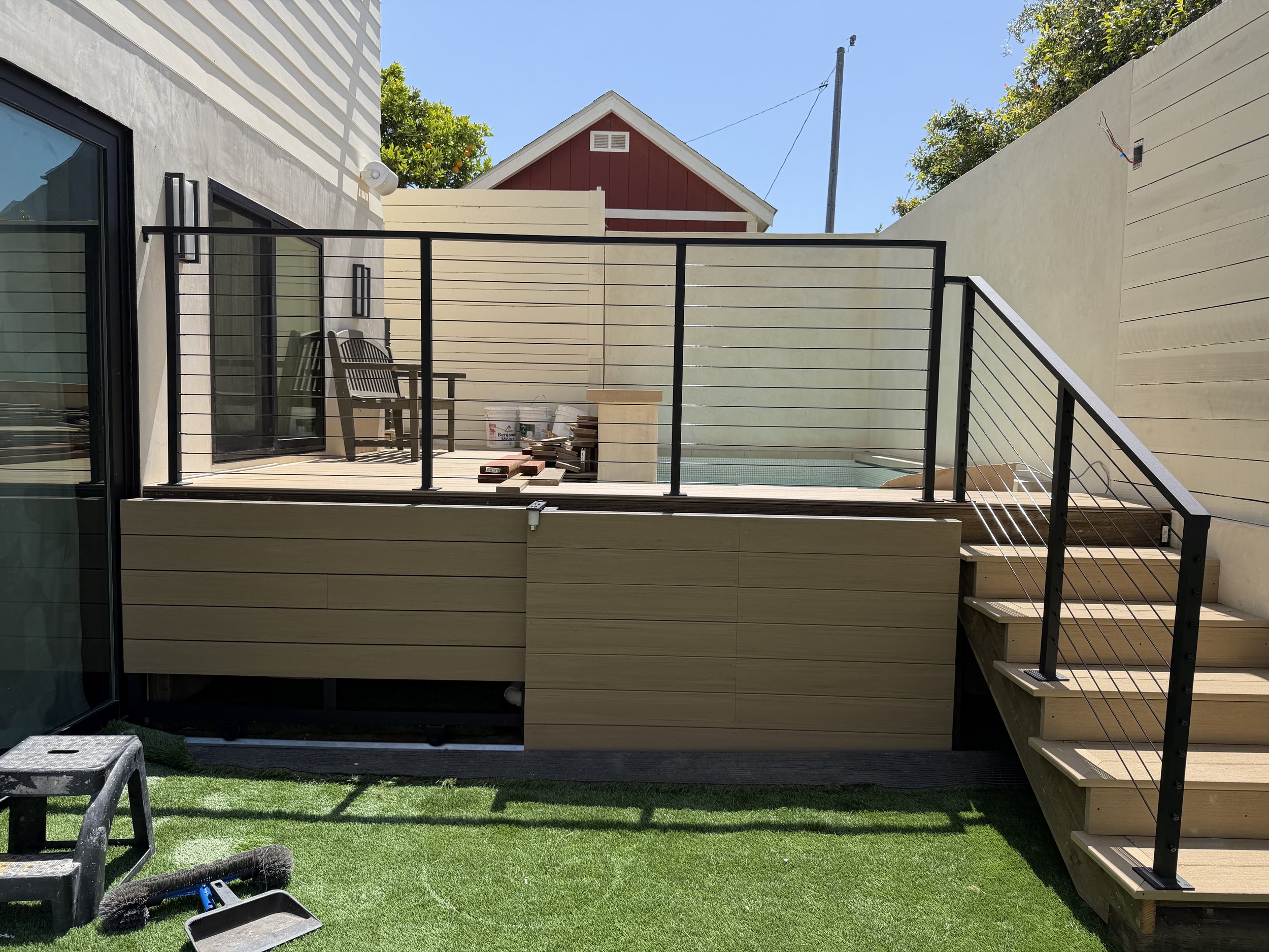 [hardscaping] Composite deck, cable railing and plunge pool under construction in a Santa Monica backyard