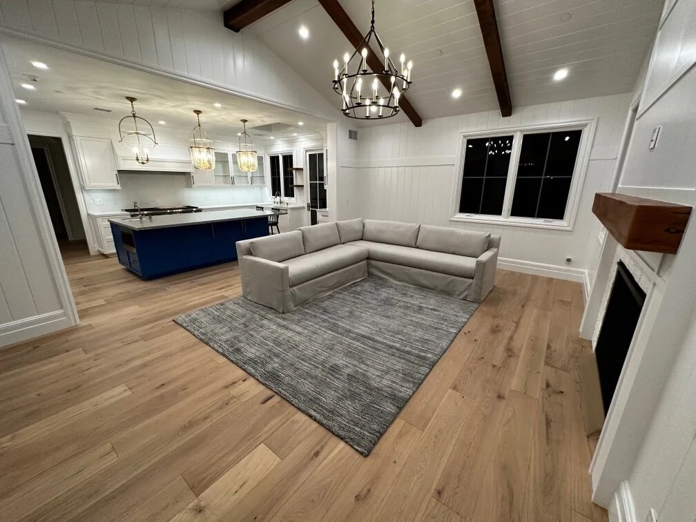 [home-additions] Open-concept great room and kitchen with a vaulted beamed ceiling and ring chandelier in Los Angeles