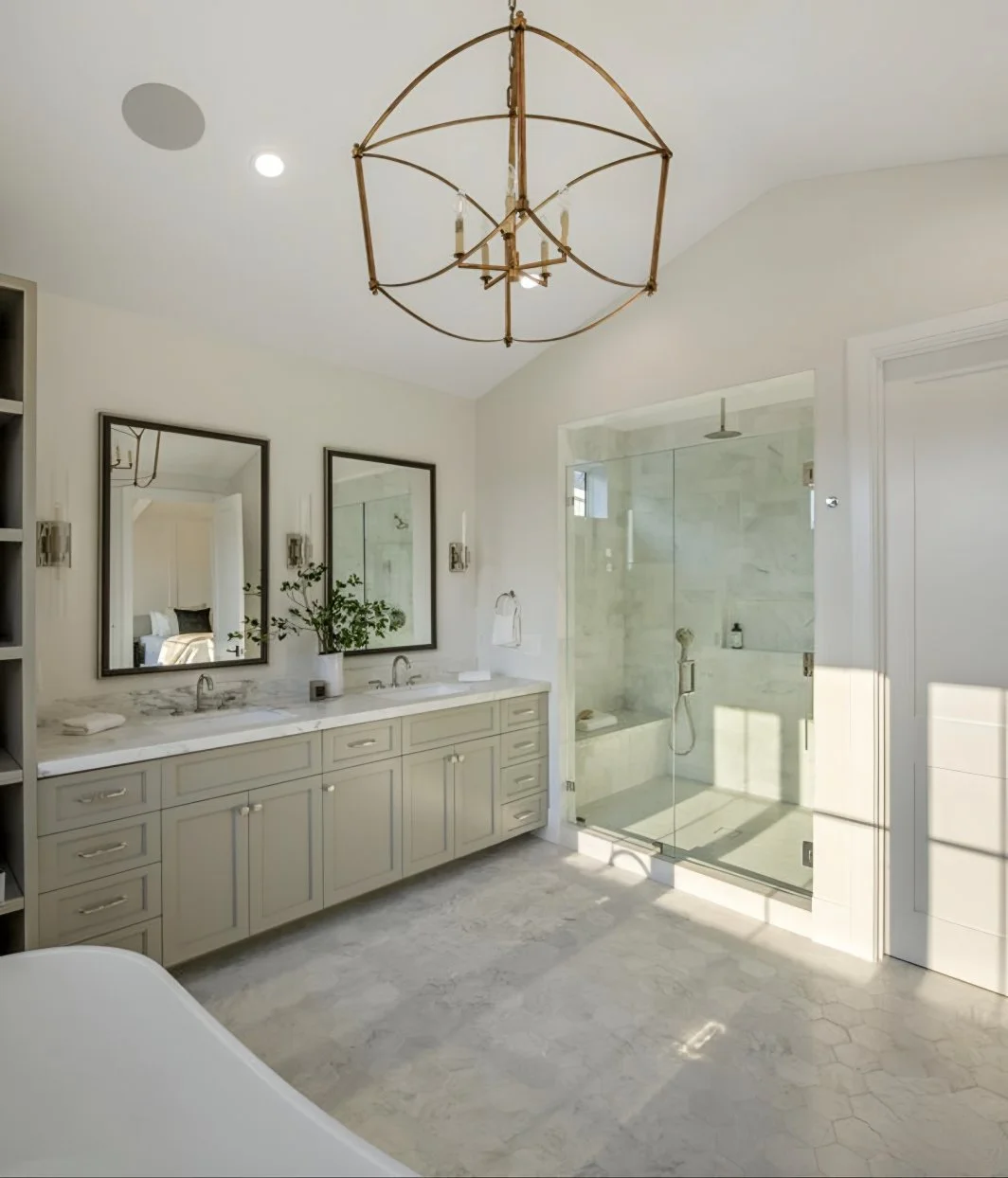Modern white bathroom with double vanity, two mirrors, a glass-enclosed shower, and a chandelier hanging from the ceiling.