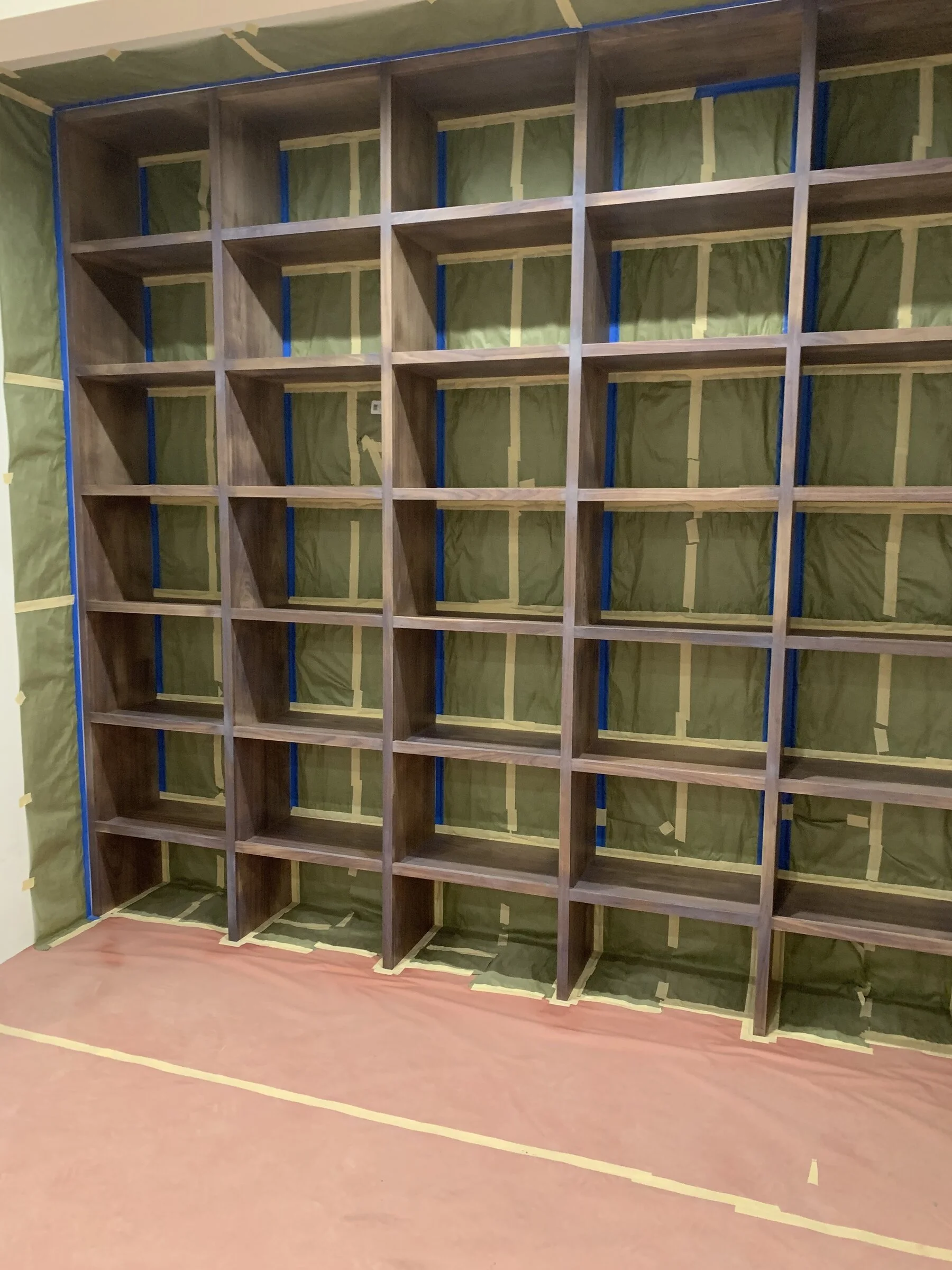 [new-construction] Floor-to-ceiling custom walnut grid bookshelf in a Los Angeles home