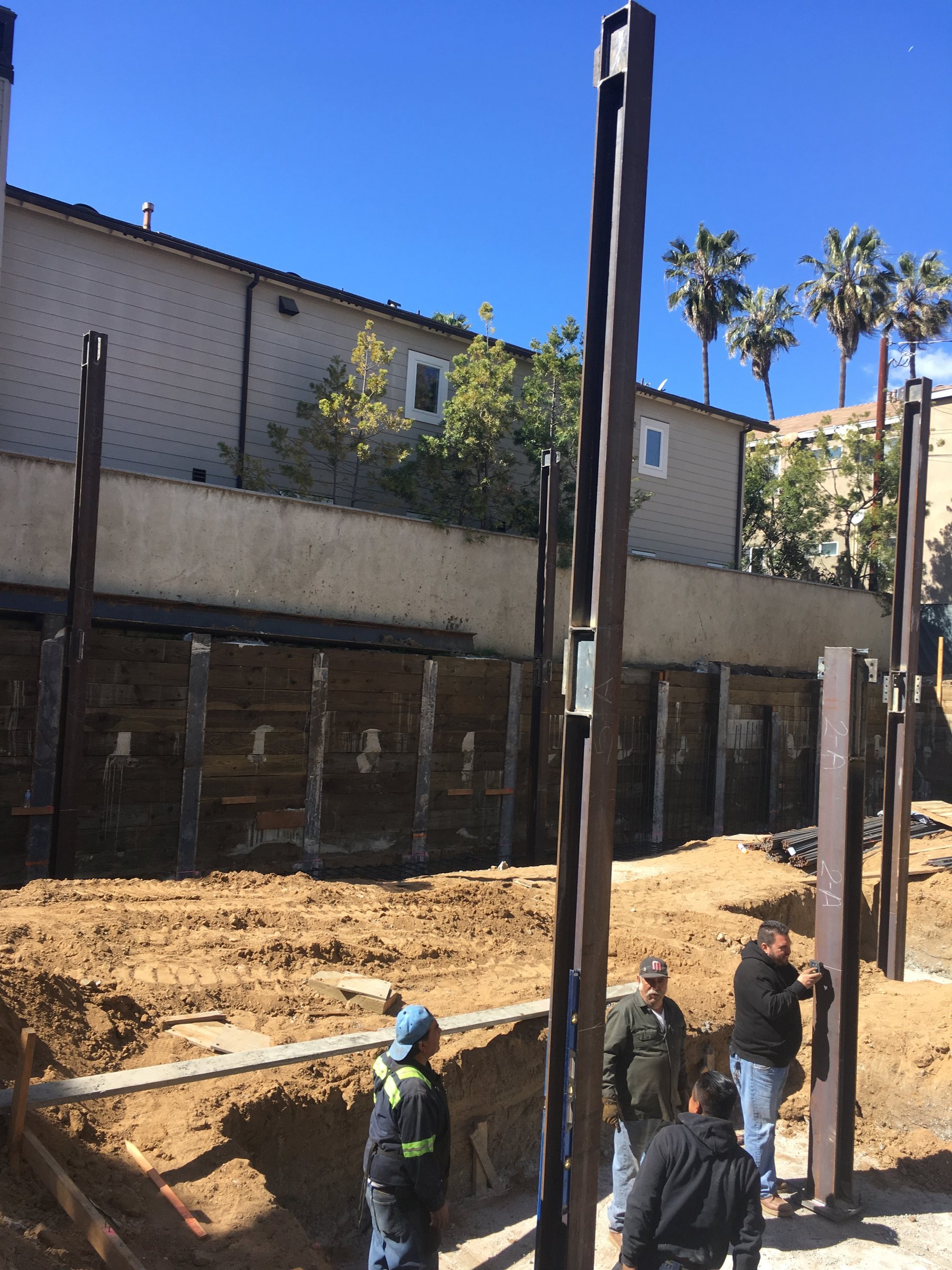 [new-construction] Construction crew setting and plumbing structural steel columns on a Santa Monica new build