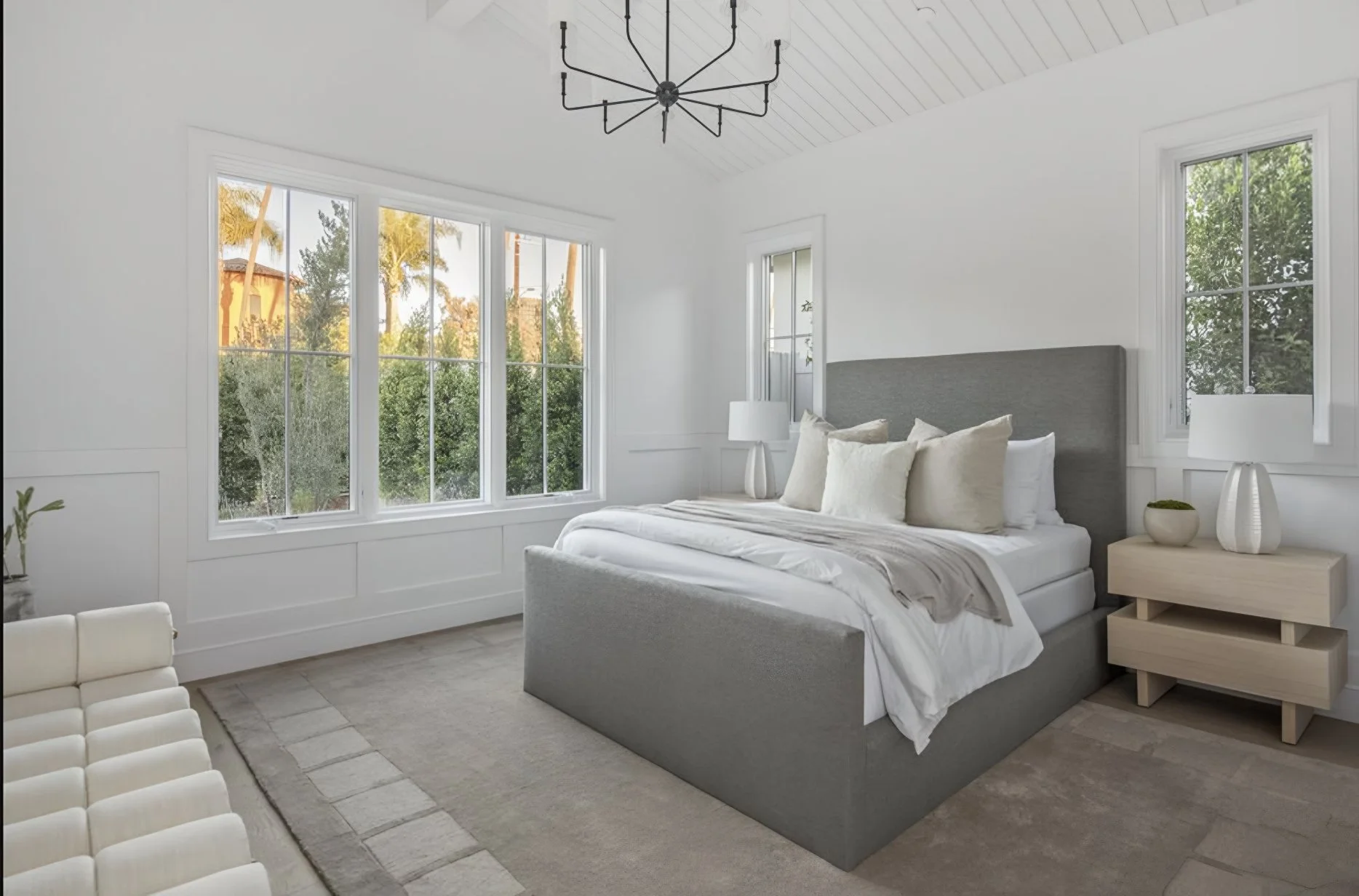 [adu-construction] Guest bedroom with vaulted shiplap ceiling, bay window, and treetop views in a Brentwood custom home
