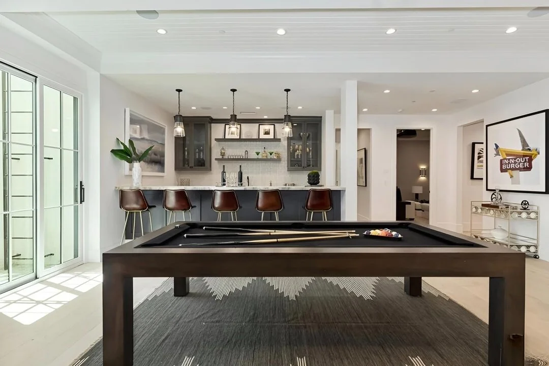 Game room with billiards table, wet bar, and leather bar stools in a Cheviot Hills custom home