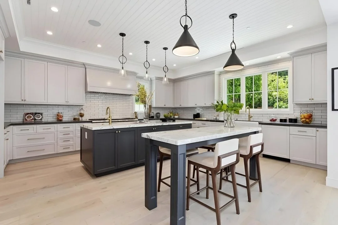 [kitchen-remodeling] Modern farmhouse kitchen with two islands, white cabinetry, subway tile, and brass fixtures, Cheviot Hills custom home